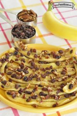 Baked banana halves with raisins and a pecan topping.