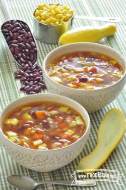 Bean, corn and summer squash soup in bowls.