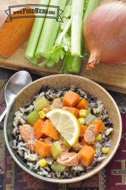 Bowl of rice with a salmon and vegetable topping.