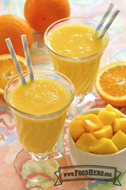 Bright orange smoothies in glasses with straws.