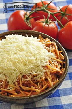 Big bowl of spaghetti topped with grated parmesan cheese.