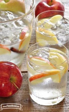 Glasses of refreshing Apple Cinnamon Flavored Water are shown with an apple slice garnish.