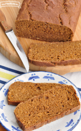 Sliced loaf of whole-wheat bread with evenly space air pockets. 