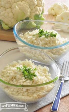 Two bowls of grated cauliflower garnished with parsley.