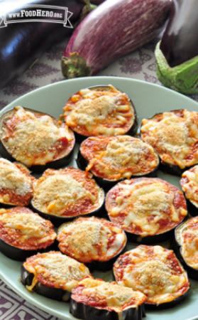 Plate of eggplant rounds with red sauce and mozzarella topped with breadcrumbs.