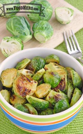 Bowl of seasoned and browned brussels sprout halves. 