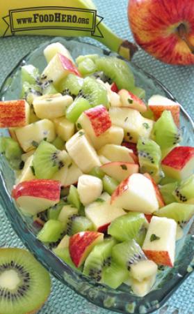 Colorful mix of chopped fruit with dressing.
