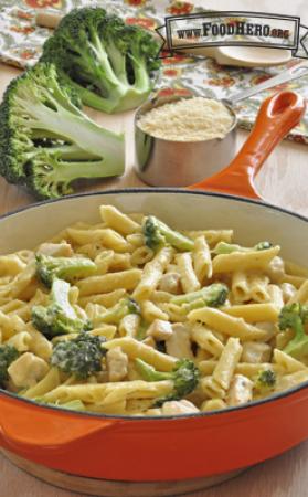 Creamy pasta and broccoli in a skillet.