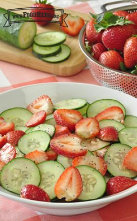 Strawberry and cucumber slices coated with poppy seed dressing.