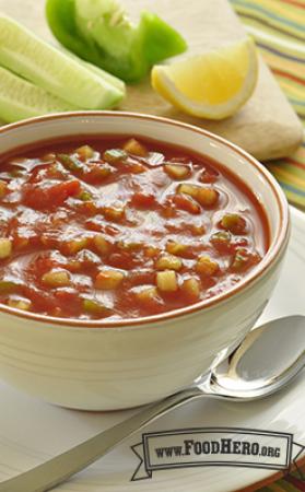 Small bowl of tomato based chunky vegetable soup.