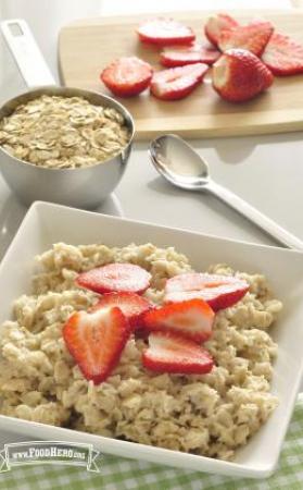 Bowl of oats served with sliced strawberries.