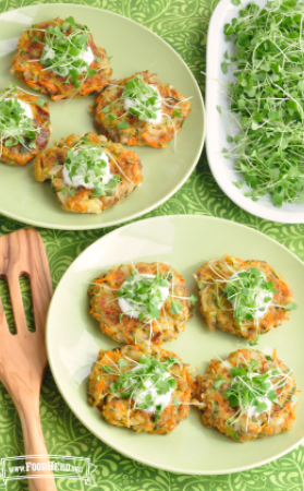 Plate of vegetable and potato patties served with a creamy sauce and microgreens on top.