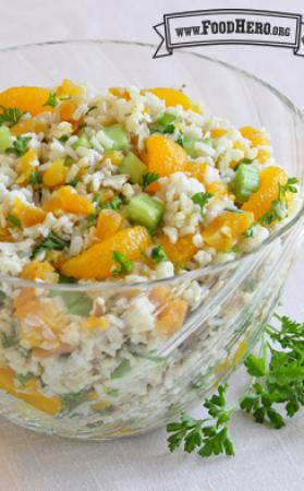 Big bowl of a colorful mixture of rice, orange and parsley.