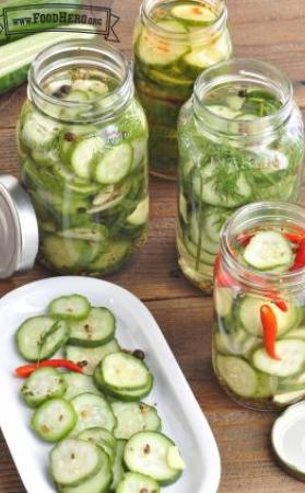 Sliced cucumbers in mason jars with pickling brine. 