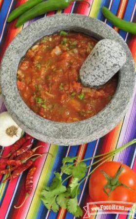 Bowl of textured tomato salsa.