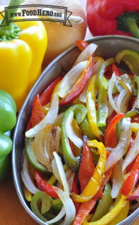 Bowl of tender bell pepper and onion slices.