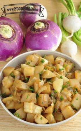Bowl of browned turnips with parsley. 