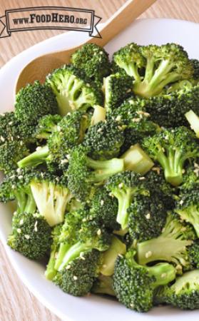 Bowl of tender broccoli sprinkled with sesame seeds. 