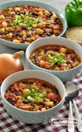 Colorful bowls of thick chili served with green onion.