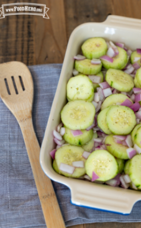 Platter of seasoned cucumber and red onion slices.