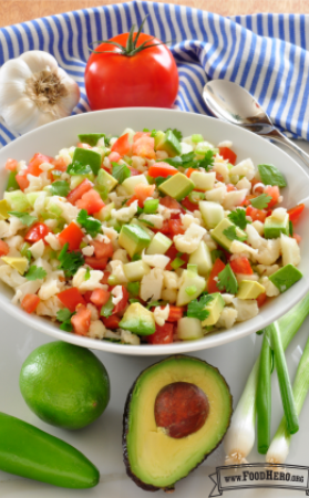 Bowl of colorful diced vegetables with dressing.