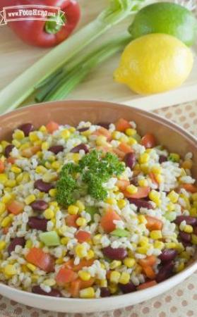 Bowl of barley, bean and vegetable salad garnished with parsley.