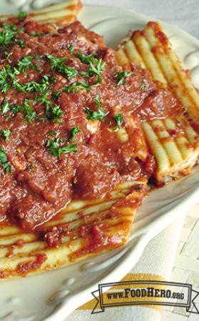 Plate of stuffed cheese pasta with red sauce and fresh parsley.