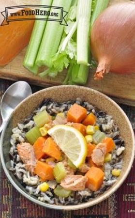 Bowl of rice with a salmon and vegetable topping.