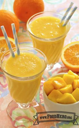 Bright orange smoothies in glasses with straws.
