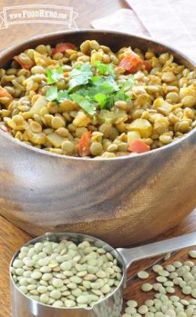 Bowl of seasoned lentils with vegetables garnished with cilantro.