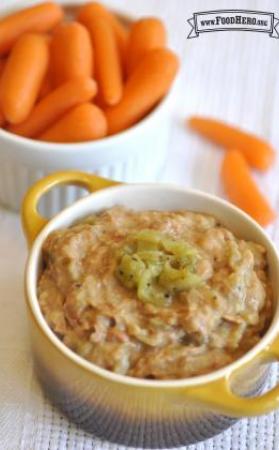 Bean dip topped with jalapeno peppers served with baby carrots. 