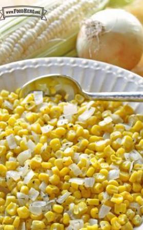 Bowl of sauteed corn and small onion pieces.