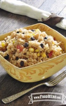 A seasoned mix of brown rice, black beans and corn is shown in a serving bowl.