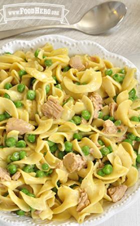 Bowl of egg noodles with peas and tuna mixed in. 