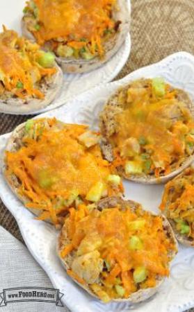 Plate of english muffins topped with a tuna mix and cheese.