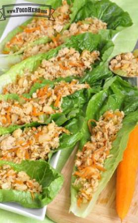 Plate of lettuce boats filled with a turkey and carrot mix.