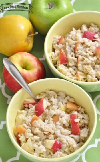 Homemade oatmeal with chopped apple and warm spices are shown in bowls.