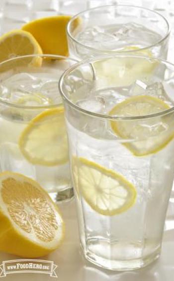 Glasses of ice water with thin lemon slices.