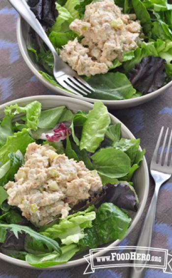 Creamy salmon mix on lettuce in a bowl.