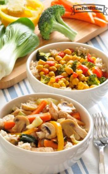 Two bowls with rice and a variety of stir-fried vegetables.