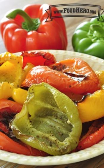 Multicolored bell pepper halves with blistered skin in a bowl. 
