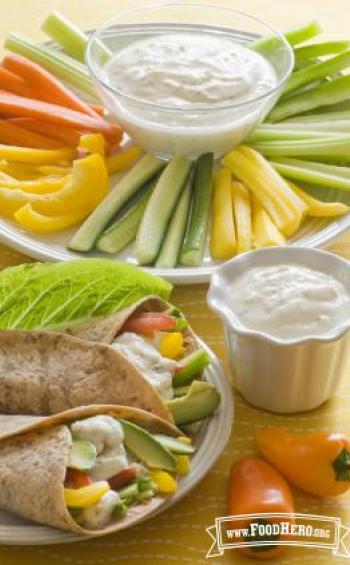 Yogurt dip served in a veggie wrap and sliced vegetables.