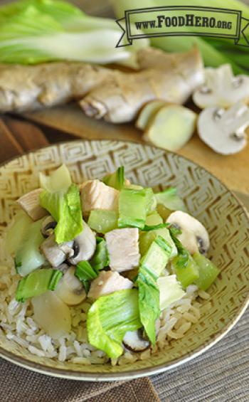 Plate of rice with a turkey and vegetable topping.