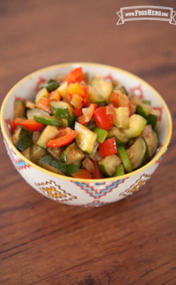 Small bowl with a tender zucchini and vegetable mix.