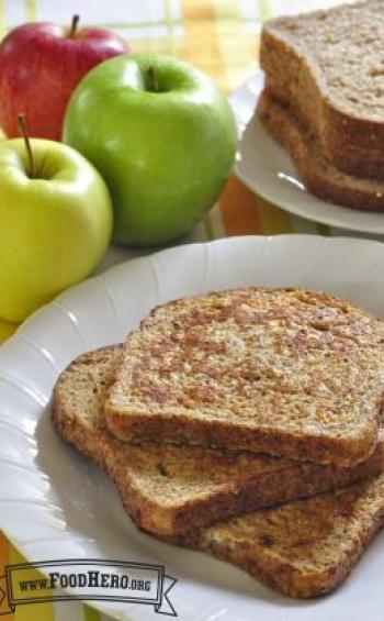 Slices of french toast cooked with applesauce, vanilla and cinnamon are displayed on a plate.
