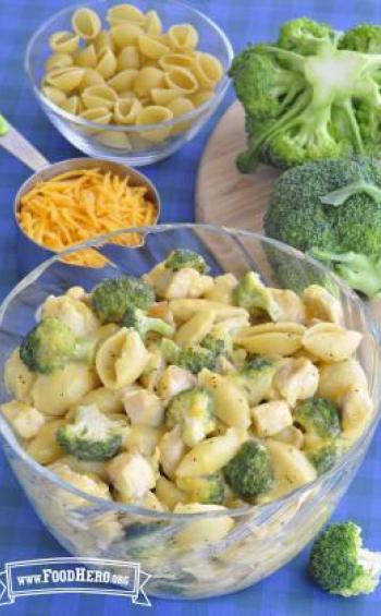 Bowl of cheesy pasta with broccoli florets.