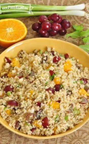 Large bowl of a colorful mix of bulgur, fruit and vegetables.