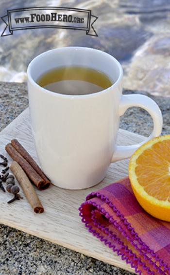 Mug of steaming hot cider drink.