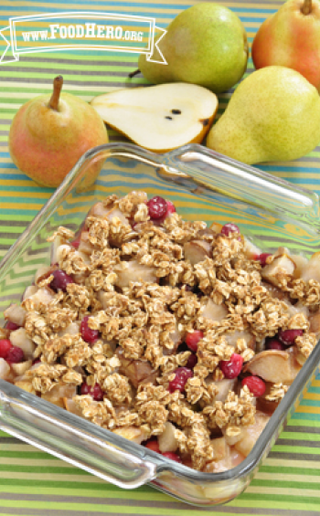 Baking dish of baked pear and cranberries with an oat topping. 