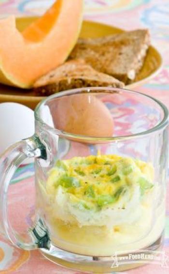 Egg omelet topped with cheese in a mug.